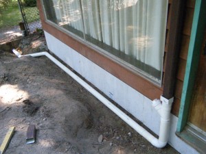 solid pipe conveys rainwater away from house